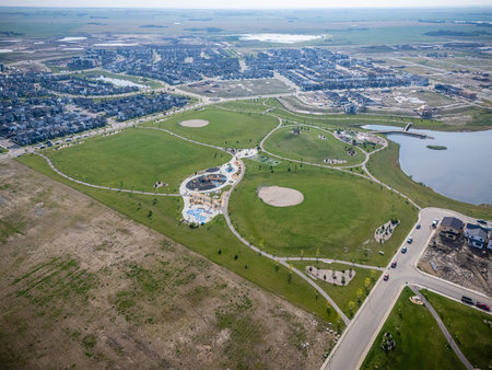 Aerial view of Brighton, a modern residential community in Saskatoon, Saskatchewan, featuring new homes, ponds, and green spacesの写真素材
