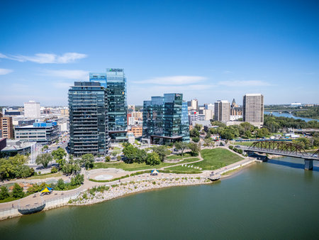 Aerial view of downtown Saskatoon, Saskatchewan, showing the city skyline, river, and bridges.の写真素材