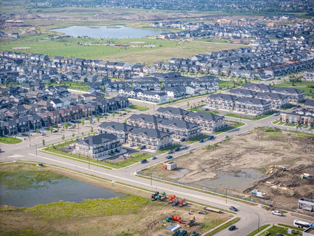 Aerial view of Brighton, a modern residential community in Saskatoon, Saskatchewan, featuring new homes, ponds, and green spacesの写真素材