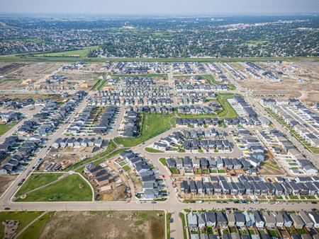 Aerial view of Brighton, a modern residential community in Saskatoon, Saskatchewan, featuring new homes, ponds, and green spacesの写真素材