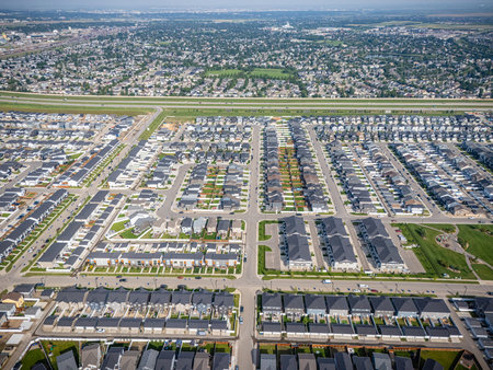 Aerial view of Brighton, a modern residential community in Saskatoon, Saskatchewan, featuring new homes, ponds, and green spacesの写真素材