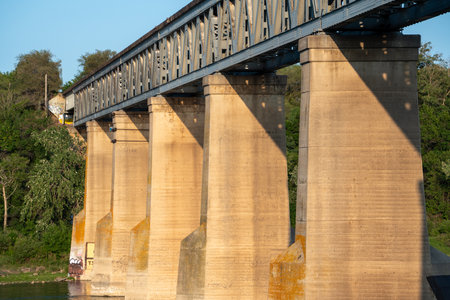 Bridge with four pillars and a train on it. The bridge is old and has a rustic lookの写真素材