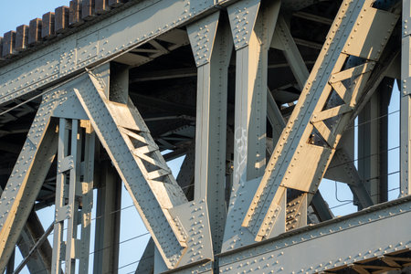 The bridge is made of metal and has a lot of holes in it. The holes are in the middle of the bridge...