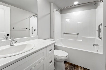 Bathroom with a white toilet and sink. The bathroom is clean and well-maintained