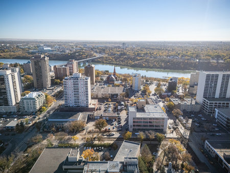 Aerial of downtown Saskatoon showing bridges, skyline, and colorful autumn trees.の写真素材