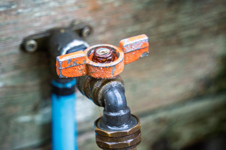 Rusty faucet with a silver handle. The faucet is oldの写真素材
