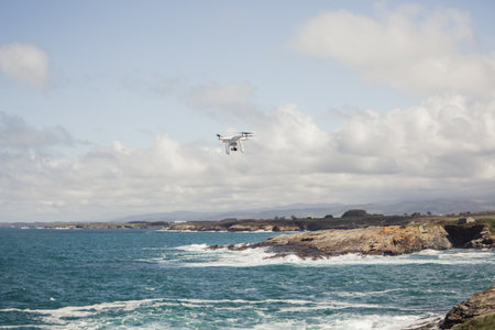 Drone flying in coastal area, views of the rocks and the seaの写真素材
