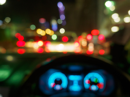 abstract blurred traffic jam at after work time during night view from inside a carの写真素材