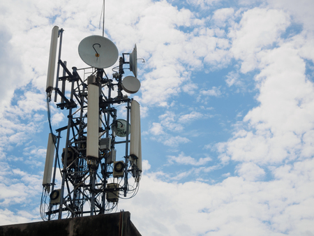 The cellular tower with white and blue sky backgroundの写真素材
