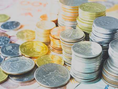 Stack of coins on banknotes money backgroundの写真素材