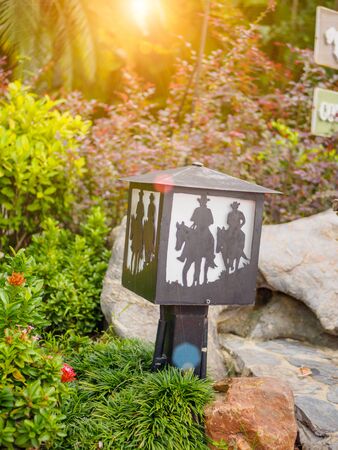 cowboy bollard light in garden with warm light backgroundの写真素材