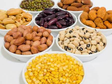 Almond, Cashew nuts, yellow bean, green bean, rice, fettucine, all put on small white cup and on white backgroundの写真素材