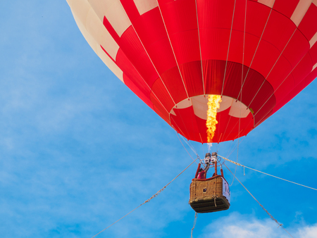 colorful of Hot air balloon with fire and dark blue sky background in eveningの写真素材
