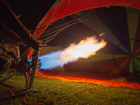 Hot flames bursts into the hot air balloon, getting ready for the ascent.の写真素材