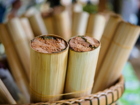 "Khao Lam" Thai dessert , coconut milk with sticky rice in bamboo, Put in bamboo weave basket.の写真素材
