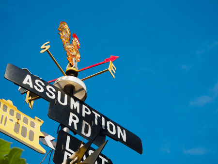 Rooster Weather vane - set against a blue sky and cloudの写真素材