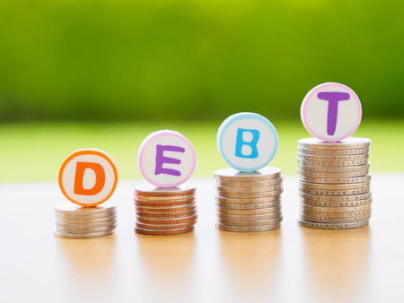 Stack of coins in debt conceptの写真素材