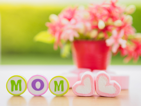 mother's day concept. MOM alphabet with marshmallow in the shape of heart and flower on backgroundの写真素材