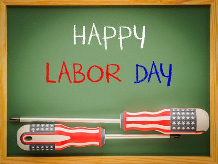 Labor day background concept - many handy tools with labor day text on blackboard background top viewの写真素材
