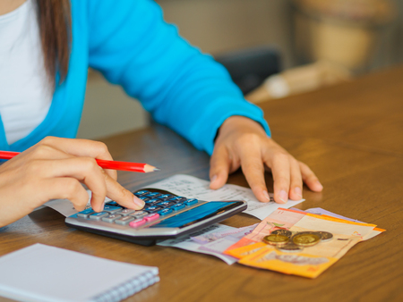 woman working with calculator, business document and laptop computer notebookの写真素材