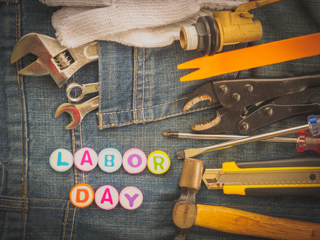 Labor day background concept - Jeans, many handy tools with labor day text on Jeans background top viewの写真素材