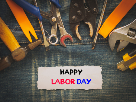Labor day background concept - Jeans, many handy tools with labor day text on Jeans background top viewの写真素材