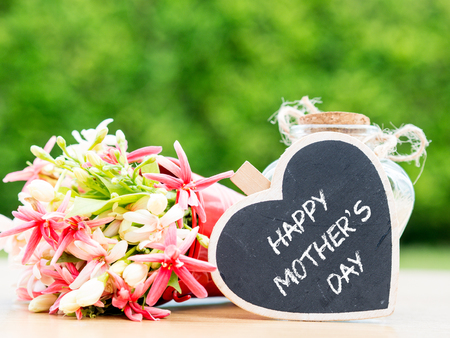 mother's day concept. LOVE MOM alphabet with flower on backgroundの写真素材