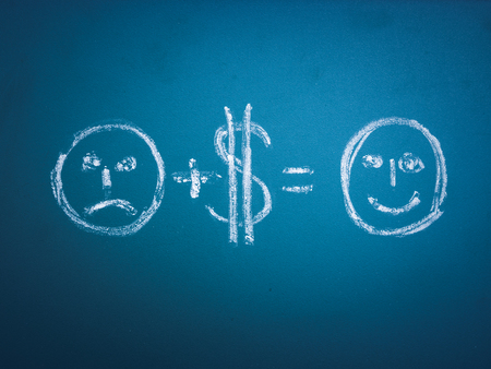 Money can change your life - concept illustrated on chalkboard. unhappy face with dollar money...