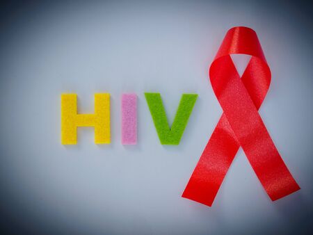 World AIDS day concept. red ribbon and HIV text