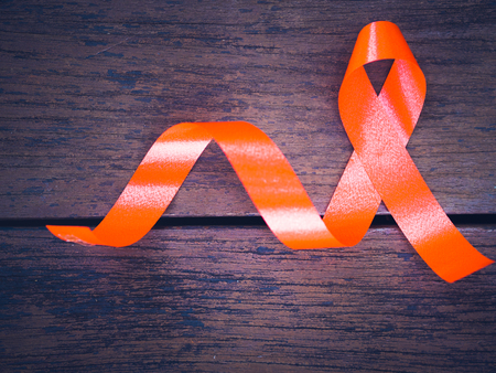 World AIDS day concept. red ribbon on wooden backgroundの写真素材