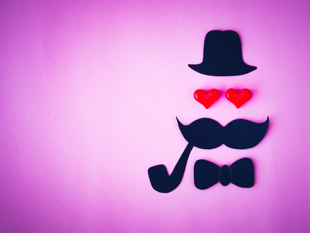 Father's day concept. black paper of dad face and Mustache on pink backgroundの写真素材