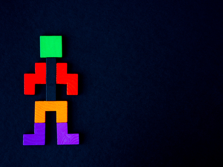 Concept of building success foundation. wooden block in the shape of human on black background. Business development and growth concept.の写真素材