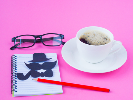 Father's day concept. compass, black glasses, coffee cup, gift and black Mustache on pink backgroundの写真素材