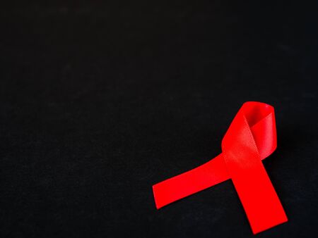 World AIDS day concept. red ribbon on black background.