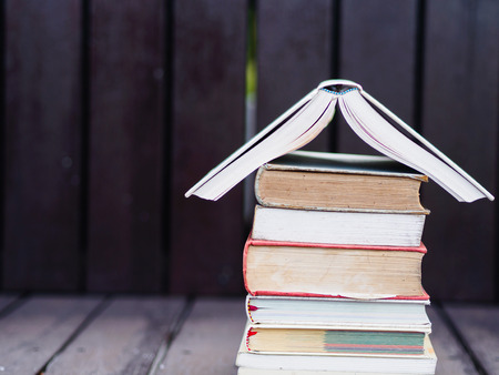 Closed up stack of books with wooden blackgroundの写真素材