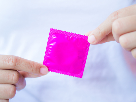 Hand holding condom, selective focus, save sex concept.の写真素材