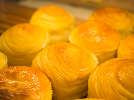 Closeup selective focus of fresh baked bread in tray rack. Food and drink concept.