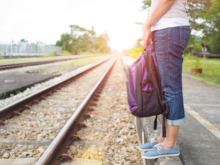 Closeup a beautiful woman with backpack on the railway platform. Travel and vacation concept.の写真素材