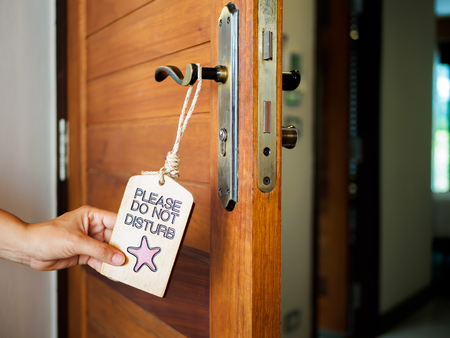 Signboard do not disturb hanging on open door in a hotelの写真素材