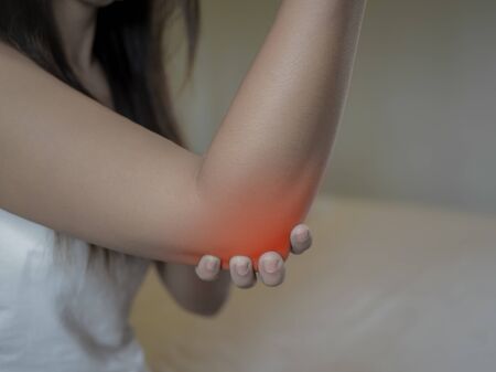 Closeup female's elbow. Arm pain and injury. Health care and medical concept.の写真素材