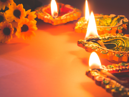 Colorful clay diya lamps lit with flowers for the Hindu Diwali festival.の写真素材