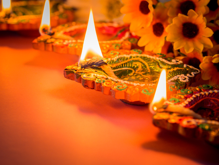Colorful clay diya lamps lit with flowers for the Hindu Diwali festival.の写真素材