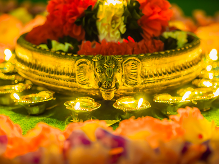 Traditional clay diya lamps lit with flowers for Diwali festival celebration.