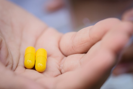 Close up of woman taking in pill, Medicine, health care and people concept.の写真素材