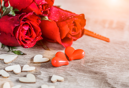 Roses and a hearts shape on wooden table background , Love, Wedding and Valentines day concept.の写真素材