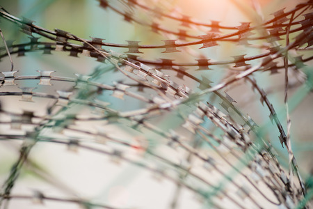Closeup a security fence with barbed wire. Human Rights and social justice abstract concept.の写真素材