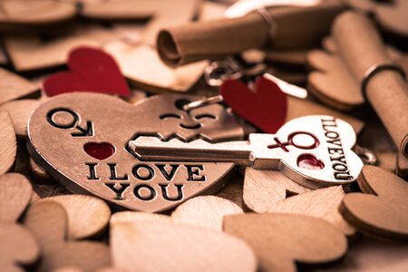 I love you Key chains in heart shaped with red heart on wooden background, vintage style. Happy...