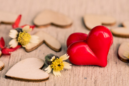 Vintage style of 2 red hearts with wooden hearts on a wooden background. Happy Valentine's Day concept.の写真素材