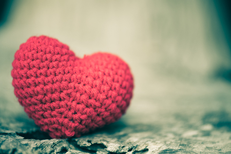 Red heart on wooden background, vintage and retro style. Happy Valentine's Day concept.の写真素材