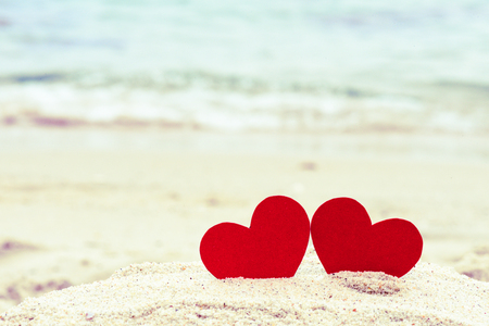Two red hearts on the summer beach. Love, Wedding and Valentines day concept.の写真素材